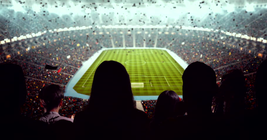 4K video of a lively stadium crowd at a nighttime soccer game, cheering confetti under bright stadium lights