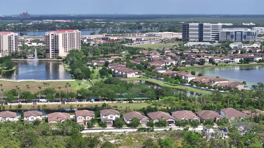 Orlando, FL United States – April 22, 2025: Aerial footage shows Lake Buena Vista’s residential neighborhoods just south-west of downtown Orlando on a clear, sunny afternoon, featuring a public school