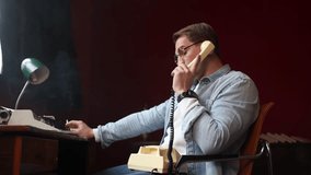 The author of literary works works in his office, creative writing and its complexities. A male writer is sitting at his desk and talking on the phone. A vintage-style office with a typewriter and a - Powered by Shutterstock - Get 15% off with code: PIKWIZARD15