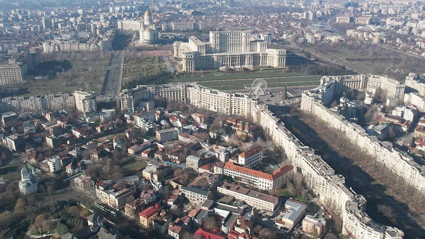 Aerial drone view over Bucharest downtown cityscape, Romania. Palace of Parliament, National Salvation Cathedral, The Patriarchal Cathedral and Boulevard Unirii.
