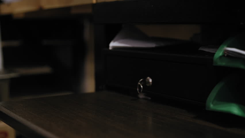 Close-up shot of a fast food cashier's hands receiving cash from a customer and placing it into the cash register.