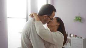 Middle-aged hispanic couple embracing lovingly in a bright living room suggests warmth and affection. - Powered by Shutterstock - Get 15% off with code: PIKWIZARD15