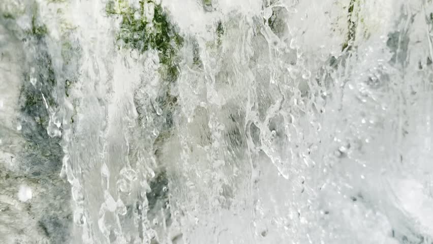 Video documentation of a detail of the sulphurous water flowing over limestone rock formations typical of the free hot springs of Saturnia, creating a natural environment 