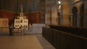 Blurry church interior displaying decorated altar and empty pews, creating a serene atmosphere with religious architecture and dim lighting. - Powered by Shutterstock - Get 15% off with code: PIKWIZARD15