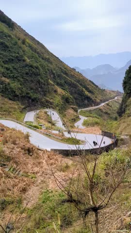 Landscape of steep mountain passes in Dong Van Global Geopark - Tham Ma slope in spring noon: Dong Van District, Ha Giang, Vietnam March 6, 2025
