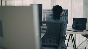 Female engineer works at desk with multiple screens and code in modern tech environment. Concept of development, software, productivity, and women in technology. - Powered by Shutterstock - Get 15% off with code: PIKWIZARD15