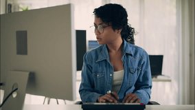 Asian female developer focused on screen while working at desktop computer in modern tech office. Concept of coding, software, engineering, and women in technology. - Powered by Shutterstock - Get 15% off with code: PIKWIZARD15