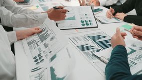 A diverse group of business professionals engages in a collaborative meeting, analyzing financial data through charts and graphs in a modern office, fostering teamwork and innovation. SACTR - Powered by Shutterstock - Get 15% off with code: PIKWIZARD15