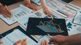 A diverse team of professionals collaborates in a modern office, analyzing data through charts and graphs. They share ideas and insights, fostering innovation and teamwork. SACTR - Powered by Shutterstock - Get 15% off with code: PIKWIZARD15