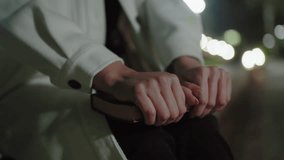 Close up woman in white coat firmly gripping book, distant bokeh lights softly glowing, highlighting serene night mood, capturing subtle hand details and calm warm atmosphere - Powered by Shutterstock - Get 15% off with code: PIKWIZARD15