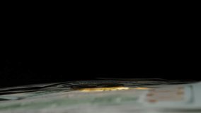 Hand Holding a Golden Ethereum Coin Above a Stack of US Dollar Bills, Symbolizing the Exchange of Traditional Currency for Cryptocurrency - Powered by Shutterstock - Get 15% off with code: PIKWIZARD15