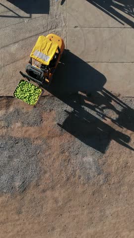 Harvest of apples, small loaders, forklift trucks, machines load, put large wooden boxes full of green apples on top of each other. top view, aero video.