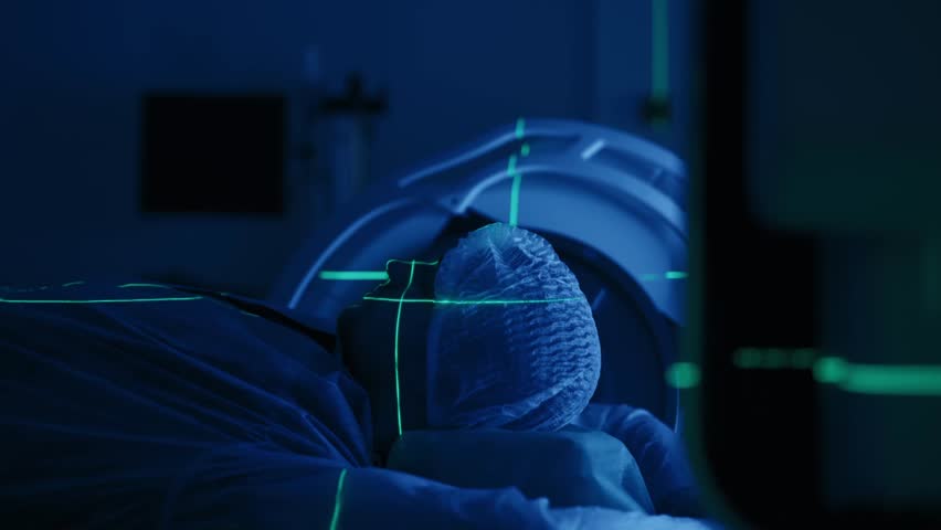 A young man undergoes radiation therapy for cancer at a state-of-the-art ocncology center. Concepcion of medical technology and theropy for cancer patients.
