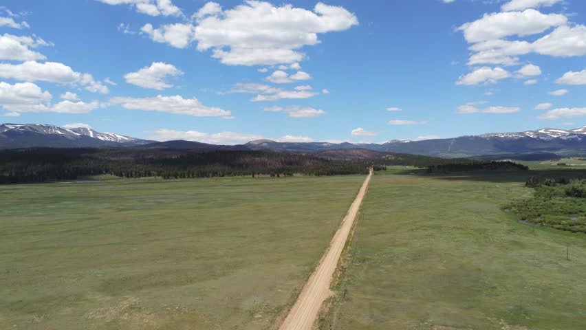 Dirt road in the Rocky Mountains in Colorado light clouds