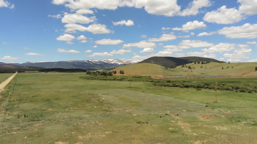 Dirt road in the Rocky Mountains in Colorado light clouds