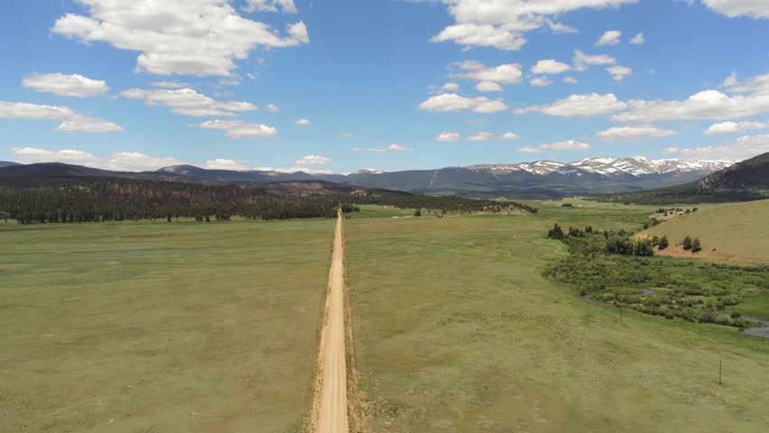 Dirt road in the Rocky Mountains in Colorado light clouds