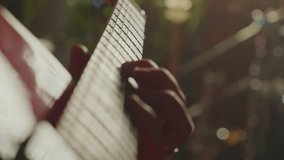 Guitarist's hand gliding across fretboard of vibrant red electric guitar during intense live musical performance, capturing raw passion and musical skill - Powered by Shutterstock - Get 15% off with code: PIKWIZARD15