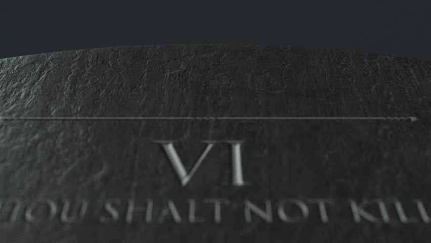 A slow close up pan across a stone tablet with the second five of the ten commandments inscribed onto them