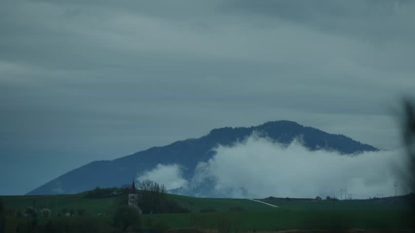 Timelapse of Distant Templar Chapel Surrounded by Forests and Moving Clouds