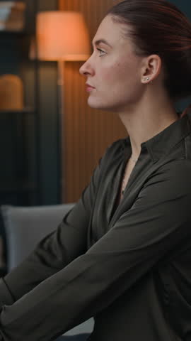 Vertical shot of young Caucasian woman sharing her feelings with African American psychologist during therapy session