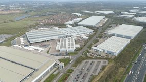 Aerial view drone flight above business park warehouse district factory units data centre quantum computing on a sunny day in the UK logistics and transport of goods economics - Powered by Shutterstock - Get 15% off with code: PIKWIZARD15
