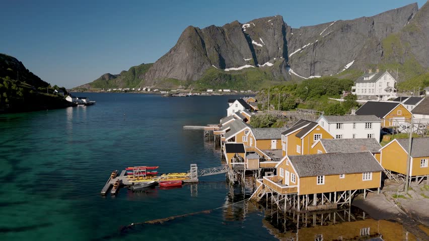 Charming houses built on stilts line the tranquil waters of a coastal village in Norway. Sakrisoy, Moskenes, Lofoten islands. Norway.