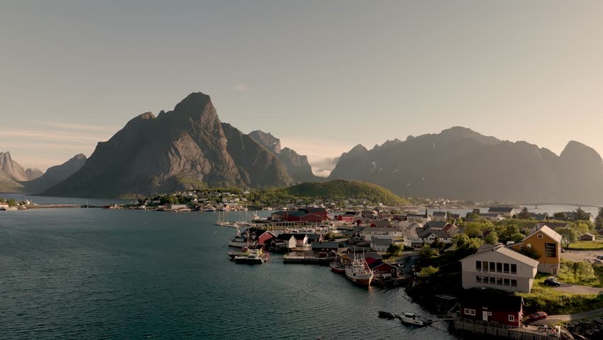A breathtaking view of the Lofoten Islands in Norway showcases stunning mountains and peaceful waters during golden hour. Reine Lofoten
