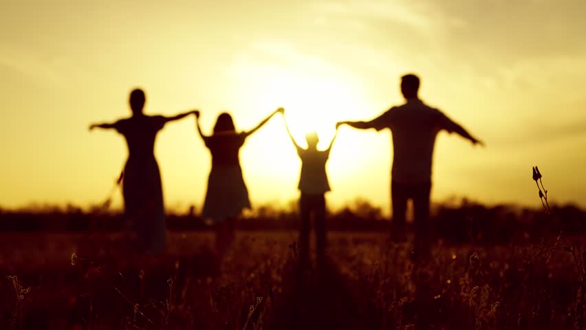 Happy family walks holding hands in park sunset. Children, parents relax carefree. Family walks on grass with. Family travel parents daughter son. Happy People traveling outdoor. Silhouette People sun