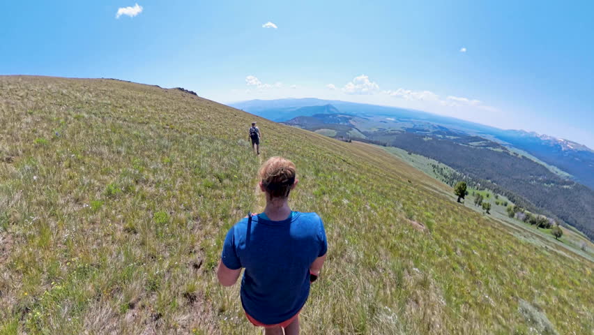 Couple Relaxes in Chairs on the Shore of Hellroaring Creek in Yellowstone National Park