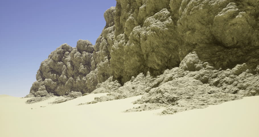 A vast expanse of sandy landscape meets rugged rock formations under a bright blue sky. The sunlight casts sharp shadows, enhancing the textures of the rocky surface.