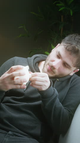 Disappointed Man Checking Empty Piggy Bank at Home - Concept of Financial Struggle and Low Savings ,vertical video