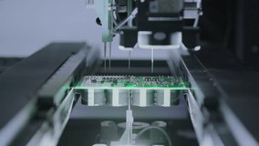 Close-up: installing electronic components. Printed circuit board moves with SMD. Automatic welding, solder machine. Production technology. Diagnose test chips and processors. Manufacture of High-tech - Powered by Shutterstock - Get 15% off with code: PIKWIZARD15