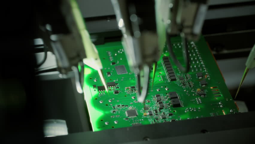 Close-up: component installation on circuit board. Electronic devices SMT industry. Factory of semiconductor, processor. PCB tiles manufacturing. Production of video cards for artificial intelligence.
