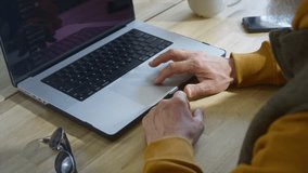 An old man opens a laptop in a restaurant. Remote work of a freelancer in a coworking. Grandpa is an IT technician or programmer. Fashionable Senior male hipster in a cafe. Modern and stylish look. - Powered by Shutterstock - Get 15% off with code: PIKWIZARD15