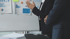 Financial analysts analyze business financial reports on a digital tablet planning investment project during a discussion at a meeting of corporate showing the results of their successful teamwork. - Powered by Shutterstock - Get 15% off with code: PIKWIZARD15