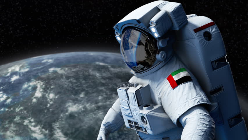 UAE Astronaut with arm patch flag floating through space. Space program. Spaceman. Earth in background. The country showing national pride. 