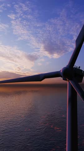 2160x3840. Windmill park. Offshore wind turbines farm on the ocean. Sustainable energy production. Green Energy, clean power, clean energy concept. Windmill turbine. ULTRA HD.