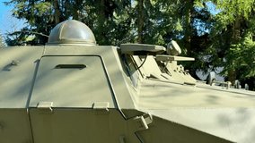 A closeup of a military vehicle highlights its turret and advanced weaponry, placed in a natural setting - Powered by Shutterstock - Get 15% off with code: PIKWIZARD15