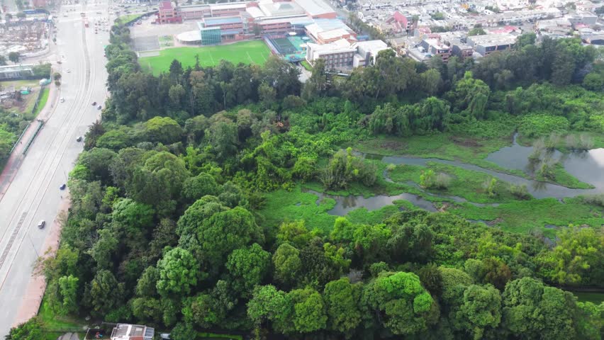 Aerial view wetland Cordoba and Suba road in middle cars moving Bogota, Colombia 4k