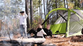Happy family enjoying exciting camping outdoors near tent. Rest in tent - Powered by Shutterstock - Get 15% off with code: PIKWIZARD15