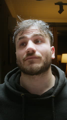 Young man staring into the fridge late at night, looking for something to eat ,vertical video
