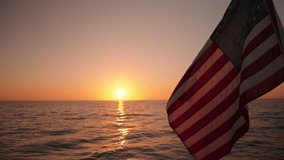Experience the stunning views of an American flag waving on a sailing ship at sunset in Key West, Florida. This vibrant sunset evokes a sense of tranquility and unforgettable peace - Powered by Shutterstock - Get 15% off with code: PIKWIZARD15