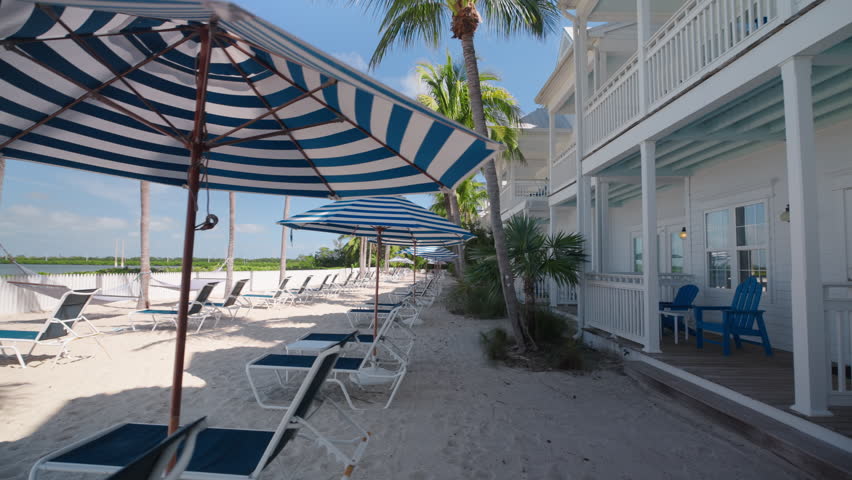 Experience the tranquil charm of a picturesque hotel located in Key West, Florida, where you can enjoy stunning beachside visuals and gentle movement through a sunny paradise, perfect for relaxation