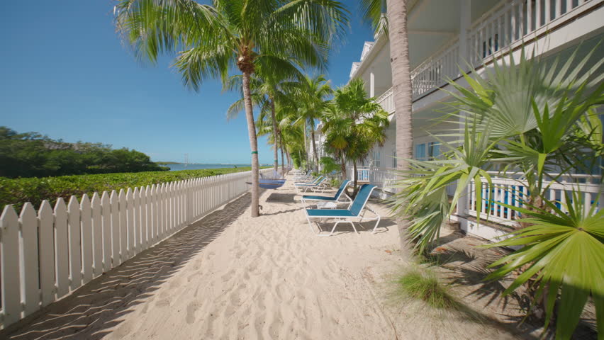 Discover Key West, Florida, with stunning hotel views and smooth camera work showcasing serene beaches, particularly at sunrise. This tropical paradise is perfect for an unforgettable getaway