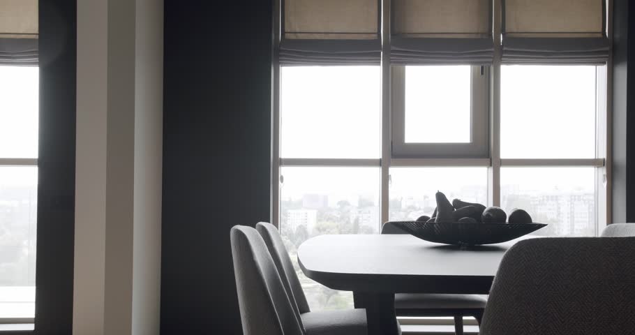 Fashionable furniture. Minimalist Home Interior. Cozy Modern Furniture Design. Luxury Modern House Interior With Dining room. Modern black wood table and white fabric chairs. Luxury Elegant Room.