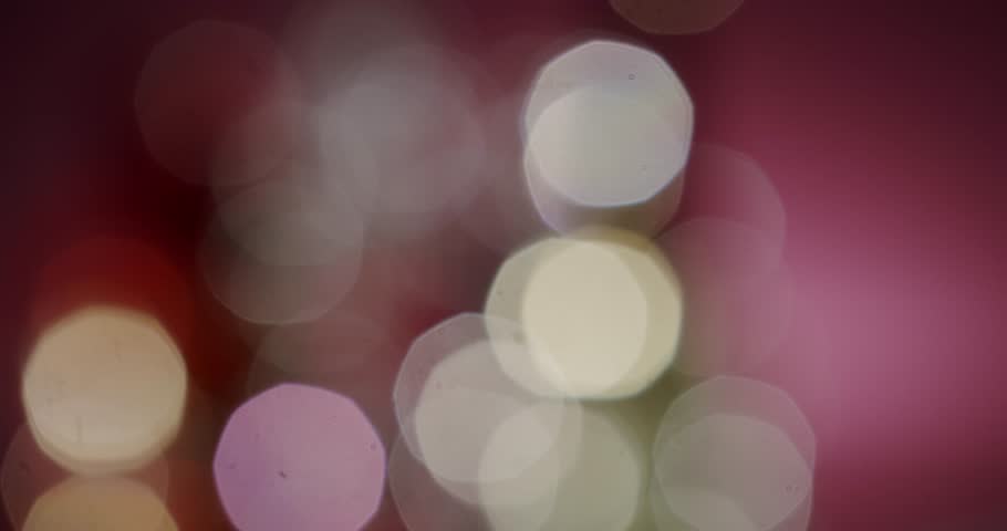 Abstract image of colorful bokeh lights with a soft pink background. Perfect for designs that evoke a dreamy, festive, or celebratory atmosphere. Multicolored Bokeh Effects