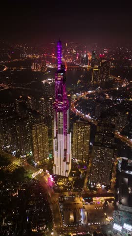 Vertical aerial of Landmark 81, the tallest skyscraper in Ho Chi Minh City (Saigon), Vietnam, illuminated against the night sky.