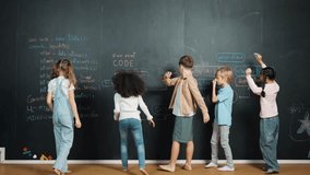 Diverse student writing engineering code or prompt at blackboard in STEM technology class. Multicultural children standing while answering questions, studying, learning programing system. Erudition. - Powered by Shutterstock - Get 15% off with code: PIKWIZARD15