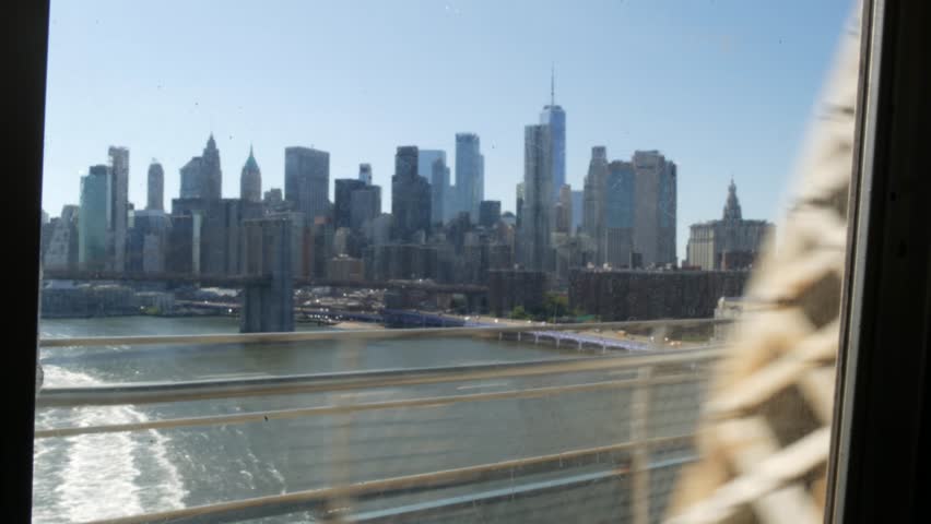 New York City subway train, Manhattan bridge. Shaking camera thru dirty window. Metro transport, metropolitan traffic. Passenger elevated railway. Cityscape, downtown skyline. World Trade Center, WTC.