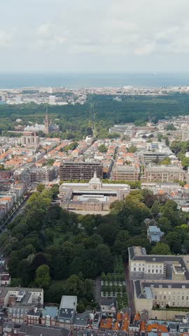 Vertical video. The Hague, Netherlands. Royal Stables. Paleistuin - park. Cloudy weather. Summer day, Aerial View, Point of interest